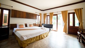 A spacious bedroom with a large bed, wooden headboard, and a bench by the window. - RungNara Pool Villa (San Sai)