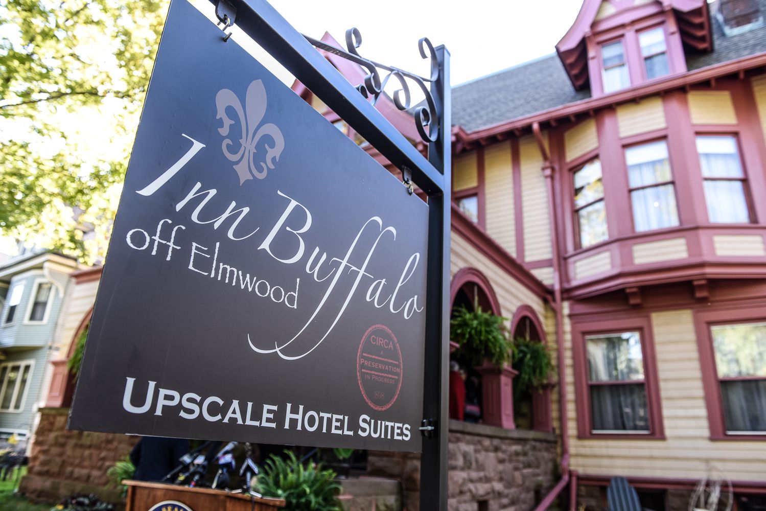 A sign for the Inn Buffalo off Elmwood, part of Upscale Hotel Suites.