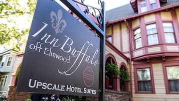 A sign for the Inn Buffalo off Elmwood, part of Upscale Hotel Suites.