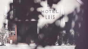 A hotel entrance with a sign reading "HOTEL LUIS" and a view of the building's facade. - Luis Stadl (Regensburg)