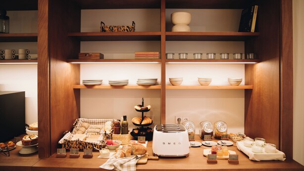 A breakfast buffet setup with various food items and a toaster. - H La Paloma Boutique (Barcelona)