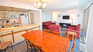 A compact living space with a kitchen, dining area, and a living room. - Thunder Island 10A (Ocean City)