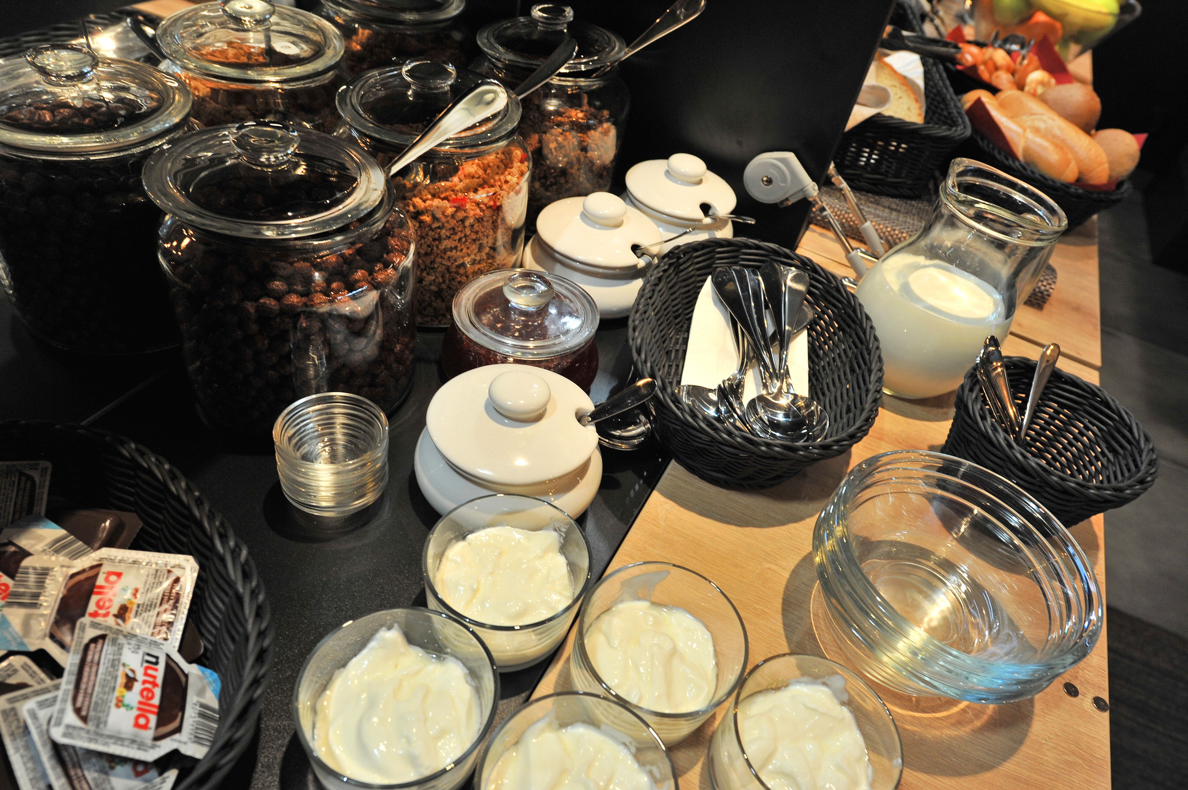 A buffet table with various food items and containers.