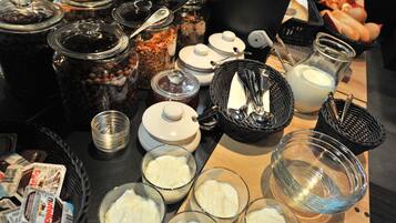 A buffet table with various food items and containers.