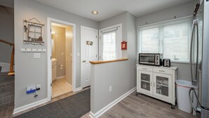 A modern kitchen with a microwave, toaster, and refrigerator.