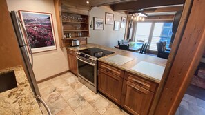 Enjoy meals in this kitchen with an oven, stovetop, and refrigerator.
