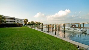 A marina with a grassy area, a dock, and a boat named 'MARTIN'. - Pelican Cove 9 - Anna Maria Island - Condo 2 Bedroom /2 Bath bay side, maximum occupancy of 5 people. (Bradenton Beach)