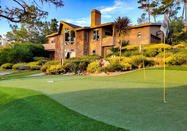 A modern house with a well-maintained lawn and a putting green. - Lx18 golfers dream retreat for concours delegance (Pebble Beach)