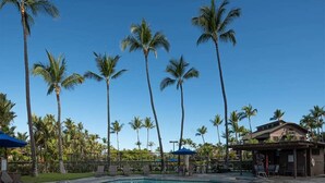A swimming pool with palm trees and lounge chairs. - Tasteful Island Decor+Lanai w/Wet Bar, Full Kitchen, TV, WiFi, Washer/Dryer Kanaloa 301 (KAILUA-KONA)