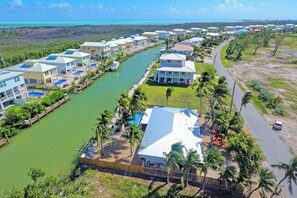 A coastal resort with multiple bungalow-style buildings, a marina, and a road. - P43 - Spacious 3 bedroom 3 bath home with Pool in the Sombrero Beach Area (Marathon)
