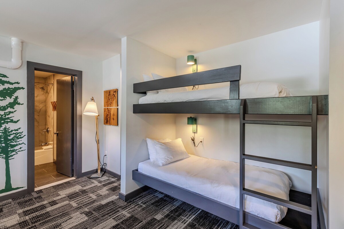 Premium bedding, memory foam beds, laptop workspace, blackout drapes