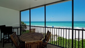 A balcony with a view of a beach.
