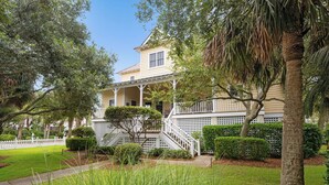 A two-story house with a porch and a staircase leading to the entrance. - Screened porches, decks, rockers, hammocks and an upstairs balcony with ocean views (Boquete)