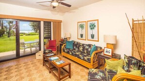 A living room with a sofa, armchairs, a coffee table, and a view of the outdoors. - Stylish Tropical Suite w/Bath+Kitchen Upgrades, WiFi, DVD, Lanai–Kaha Lani 113 (LIHUE)