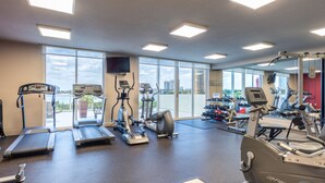 A gym with treadmills, ellipticals, and weight machines. - Spacious condo w/ terrace overlooking the bay | WIFI + Parking (Sunny Isles Beach)