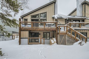 A two-story building with a wooden balcony and a staircase leading to the upper level.