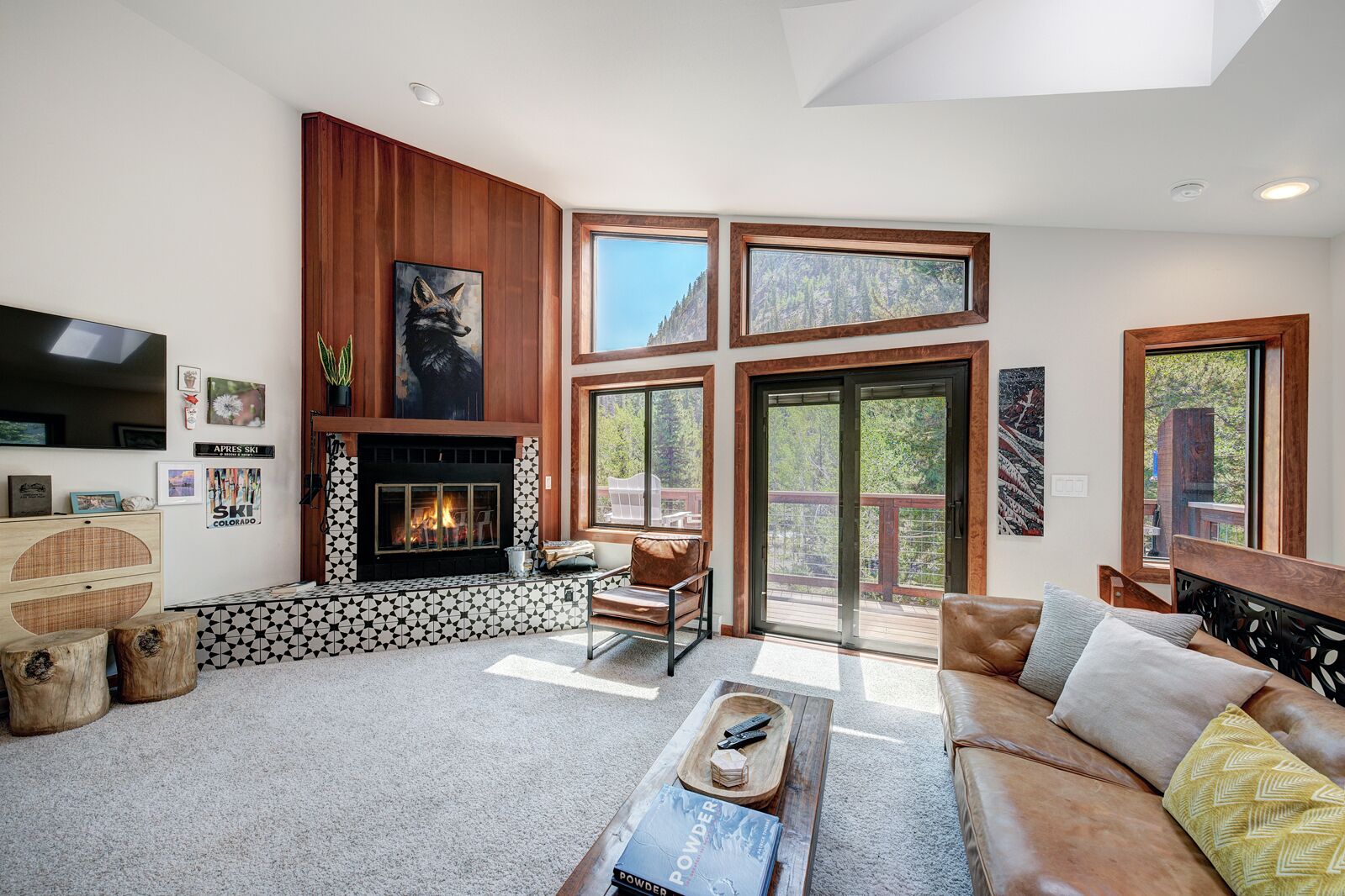A living room with a fireplace, a sofa, a coffee table, and a television.