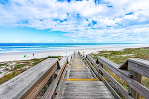 A wooden boardwalk leading to a beach with a clear view of the ocean and sky. - Harbour Village 2304 | Golf/Tennis/Pool | River View (Ponce Inlet)
