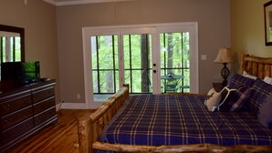 A bedroom with a wooden bed frame, a dresser, and a television on a stand. - 3 bdrms, Bonfire Pit, Screened Porch, Mountain Shade (Townsend)