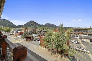 Set against a mountainous backdrop, this town offers a mix of residential and commercial buildings.