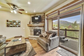 Relax in this cozy living space with a fireplace, flat-screen TV, and comfortable seating area.