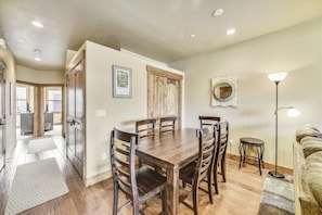 Enjoy meals in this cozy dining area with a wooden table and comfortable chairs.