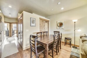 A dining area with a wooden table and chairs, a framed picture on the wall, and a floor lamp. - Luxury in the Heart of Frisco!! Beautiful, top floor condo half block off Main Street with garage and private elevator. (Frisco)