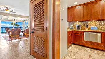 A kitchen with wooden cabinets and a stainless steel dishwasher.
