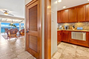 A kitchen with wooden cabinets and a stainless steel dishwasher.