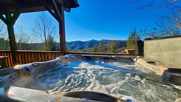 A hot tub with a view of mountains. - Cliffside Romantic Mountain Getaway - Hot Tub, Fireplace, Pet Friendly, and View (Ferguson)