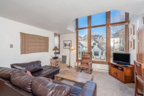 Relax in this inviting living room with a leather sofa, wooden coffee table, and flat-screen TV.
