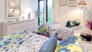 A bedroom with two beds, a dresser, a mirror, and a window with blinds. - Bright, Airy Condo w/Epic View! Wood Floors, Lanai, Full Kitchen, WiFi–Kaha Lani 225 (LIHUE)