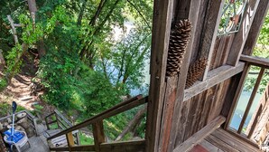 A wooden staircase leading to a deck with a view of a forest and a body of water. - Unwind on the River, Views, Beaches, Dog Friendly (Forestville)