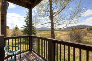 Relax on the deck with a view of the surrounding landscape and distant mountains.