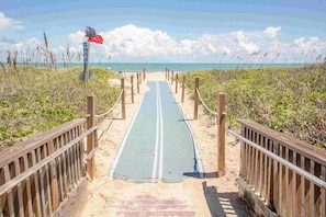A beach path leading to the ocean with wooden railings and a blue mat. - Gardenia Villa  - Lively pool;Beach across street;Dual living spaces (South Padre Island)