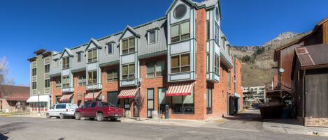 A multi-story building with a brick facade and large windows.