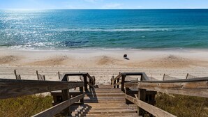 A wooden boardwalk leading to a beach with a wheelchair on the sand. - Gulf-Front, Remodeled Unit w/ Incredible Views + Free Attraction Tickets! (Seacrest)