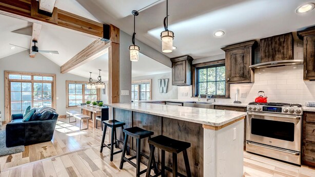 A spacious kitchen with a large island, wooden cabinets, and a modern stove. - Beautiful new 4 bed/4bath private home, 4 blocks off Main St with all the amenities!! (Frisco)