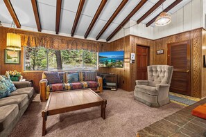 A cozy living room with a wooden ceiling, a sofa, a chair, and a coffee table. - Large Deck, Bunk Room, Garage, Close to Waterman's Landing "Agate Bay Ranch" (Carnelian Bay)