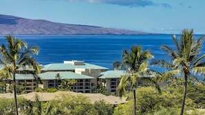 A resort with multiple buildings, a pool area, and a view of the ocean.