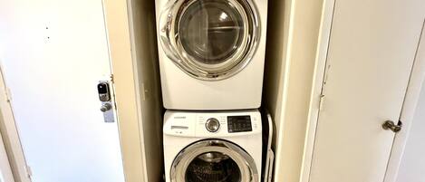 A compact, two-door laundry room with a built-in washer and dryer.