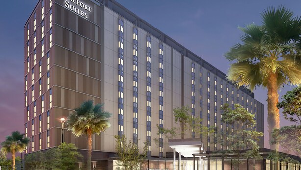 A multi-story hotel with a prominent sign reading "Comfort Suites." - Comfort Suites Tokyo Bay (Urayasu)