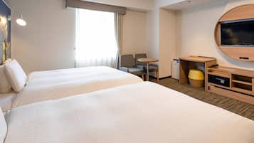 A hotel room with two beds, a desk, a chair, a TV, and a small table.