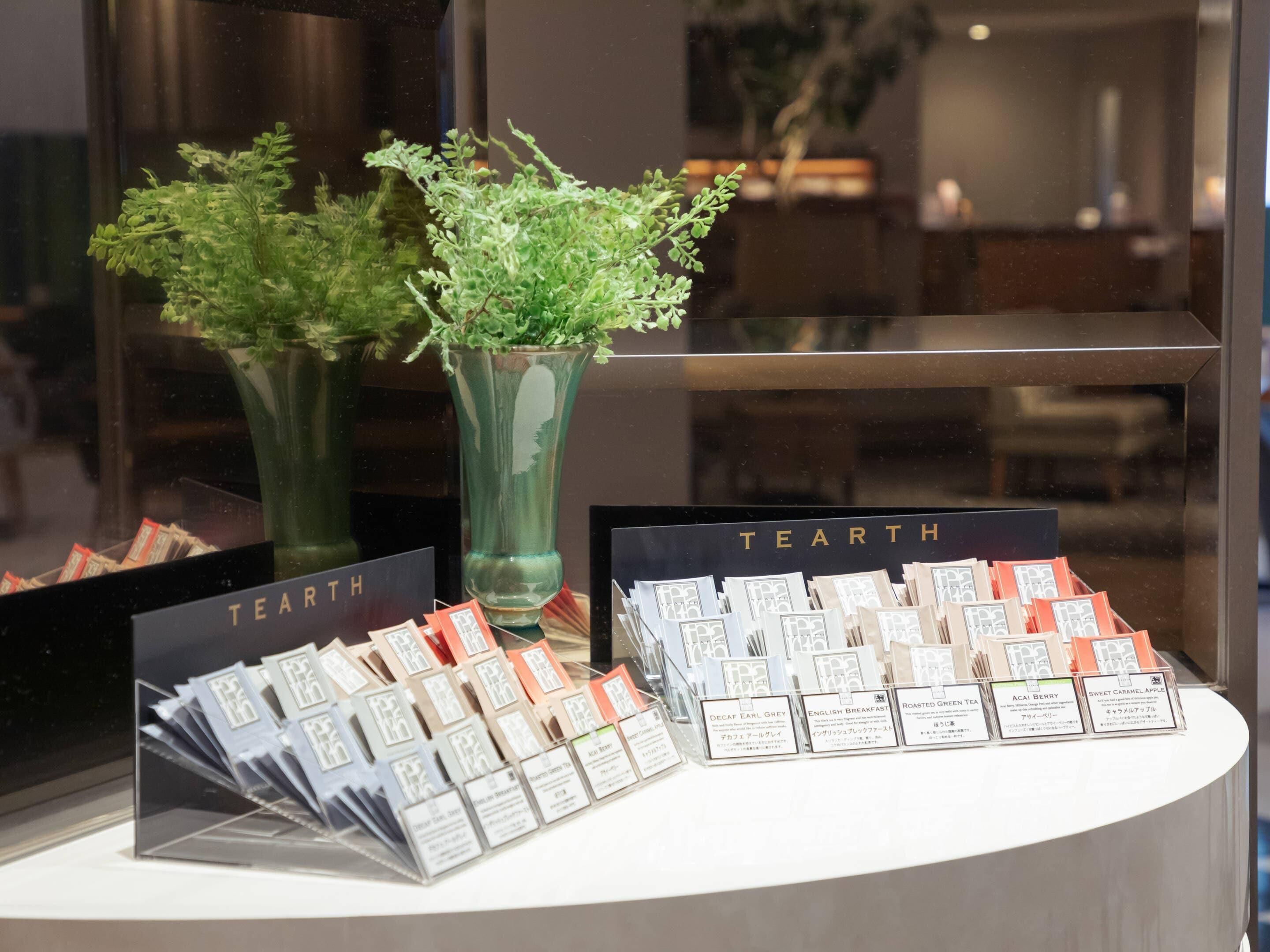 A display of tea products with labels and a sign that reads 'TEARTH'.