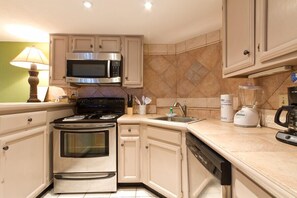 Enjoy cooking in this well-equipped kitchen with a stainless steel oven, microwave, and coffee maker.