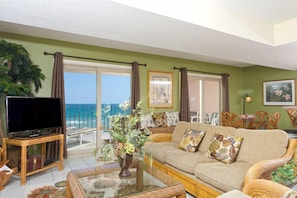 Relax in this inviting living space with a sofa set, flat-screen TV, and ocean views.