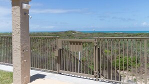 A gated area with a view of the ocean and beach.