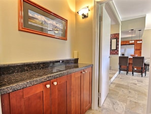 Sophisticated granite wet bar with custom cabinetry—perfect for elegant entertaining steps from the gourmet kitchen and dining area