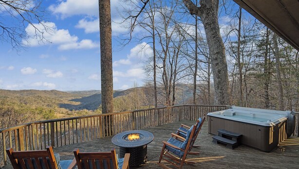 A deck with a fire pit, seating, and a hot tub overlooking a forested landscape. - Cabin w/ Views, Jacuzzi Bathtub, Fireplace, Screened Porch, Outdoor Hot Tub (Ferguson)