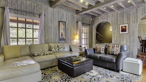 A living room with a sectional sofa, a chaise lounge, and a patterned rug. - Villa Tranquila ~ Historic Mediterranean Home, Mountain Views, Spa! (Guerneville)